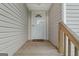 Close-up of the front door leading to a charming house with wood siding and stairs at 1704 New Hope Rd, Locust Grove, GA 30248