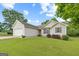 Well-kept home with a two-car garage, green lawn, vinyl siding, and fresh landscaping at 1704 New Hope Rd, Locust Grove, GA 30248