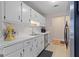 Bright kitchen with white cabinets, stainless steel appliances, tile backsplash, and countertop appliances at 1704 New Hope Rd, Locust Grove, GA 30248