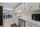 Kitchen featuring white cabinets, stainless steel appliances, and an adjacent dining area at 1704 New Hope Rd, Locust Grove, GA 30248