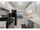 Bright kitchen features white cabinets, black appliances, and dining area at 1704 New Hope Rd, Locust Grove, GA 30248