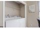 A well-lit laundry area showcasing a washer, a dryer, and wire shelving for efficient storage at 1704 New Hope Rd, Locust Grove, GA 30248
