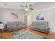 Spacious living room with hardwood floors, comfortable seating, a vaulted ceiling, and artwork at 1704 New Hope Rd, Locust Grove, GA 30248