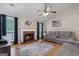 Inviting living room featuring a brick fireplace, vaulted ceiling, and comfortable gray sofas at 1704 New Hope Rd, Locust Grove, GA 30248