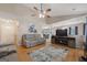An open-concept living room with hardwood floors, comfortable seating, and a view of the dining area and entryway at 1704 New Hope Rd, Locust Grove, GA 30248