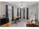 Versatile living space featuring a workstation, piano, and an abundance of natural light from the surrounding windows at 1704 New Hope Rd, Locust Grove, GA 30248