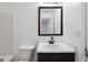 This bathroom features a shower-tub combo and a black framed mirror at 1823 Devon Sw Dr, Atlanta, GA 30311
