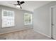 Bright bedroom features natural light, neutral carpet and a ceiling fan at 1823 Devon Sw Dr, Atlanta, GA 30311