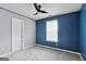 Bright bedroom features a window, neutral carpet and a ceiling fan at 1823 Devon Sw Dr, Atlanta, GA 30311