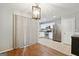 Dining area adjacent to kitchen with tile floors, white cabinets and stainless steel appliances at 1823 Devon Sw Dr, Atlanta, GA 30311
