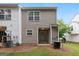 Back exterior view of property featuring sliding glass doors and green space at 1823 Devon Sw Dr, Atlanta, GA 30311