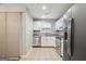 Well-lit kitchen with stainless steel appliances, ample counter space, and tile flooring at 1823 Devon Sw Dr, Atlanta, GA 30311