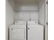 Laundry room featuring a washer, dryer, and wire shelving at 1823 Devon Sw Dr, Atlanta, GA 30311
