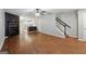 Spacious living room with hardwood floors, a fireplace, and a ceiling fan open to the kitchen at 1823 Devon Sw Dr, Atlanta, GA 30311