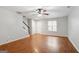 Bright living area featuring hardwood floors, a ceiling fan, staircase, and ample natural light at 1823 Devon Sw Dr, Atlanta, GA 30311