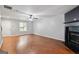 Open living space with hardwood floors, a ceiling fan, a window and a fireplace at 1823 Devon Sw Dr, Atlanta, GA 30311