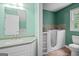 Bathroom featuring double sinks, a walk-in tub, and natural light at 2058 Sewanee Ct, Villa Rica, GA 30180