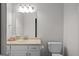 A full bathroom features a toilet, sink, vanity, and large mirror with great lighting at 2058 Sewanee Ct, Villa Rica, GA 30180