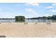 Sandy beach area at the lake with picnic tables and lifeguard stand, ideal for swimming and sunbathing at 2058 Sewanee Ct, Villa Rica, GA 30180