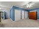 Comfortable bedroom showcasing neutral carpeting, storage closets and a ceiling fan at 2058 Sewanee Ct, Villa Rica, GA 30180