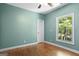 Cozy bedroom with wood floors and a large window offering natural light and outdoor views at 2058 Sewanee Ct, Villa Rica, GA 30180