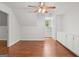 A bedroom with hardwood floors, built-in cabinets, and a ceiling fan with lights at 2058 Sewanee Ct, Villa Rica, GA 30180