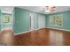Bedroom with wood floors, light-green walls, and multiple windows offering serene views at 2058 Sewanee Ct, Villa Rica, GA 30180