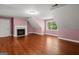 Spacious bedroom featuring a fireplace, wood floors, and dormer windows at 2058 Sewanee Ct, Villa Rica, GA 30180