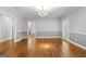 Elegant dining room featuring hardwood floors, wainscoting, and stylish lighting fixture at 2058 Sewanee Ct, Villa Rica, GA 30180