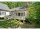 Charming exterior with covered porch, beautiful garden, and lush greenery at 2058 Sewanee Ct, Villa Rica, GA 30180
