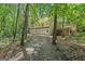 View of the rear exterior featuring an attached three car garage and a screened in porch area at 2058 Sewanee Ct, Villa Rica, GA 30180