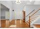 Bright foyer featuring hardwood floors, staircase, chandelier, and traditional style at 2058 Sewanee Ct, Villa Rica, GA 30180