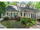 Beautiful home featuring a charming porch, black shutters, and colorful landscaping at 2058 Sewanee Ct, Villa Rica, GA 30180