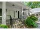 Charming front porch with stone steps, white columns, and manicured landscaping at 2058 Sewanee Ct, Villa Rica, GA 30180