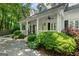 Attractive front porch with white columns, ceiling fans, and mature landscaping at 2058 Sewanee Ct, Villa Rica, GA 30180