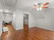 A hallway leads to a bedroom and another room, with hardwood floors and a ceiling fan at 2058 Sewanee Ct, Villa Rica, GA 30180