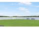 Scenic view of the lake with benches on the grassy shoreline, perfect for relaxation and enjoying the water at 2058 Sewanee Ct, Villa Rica, GA 30180