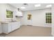 Bright laundry room with white cabinets, sink, and a door leading outside at 2058 Sewanee Ct, Villa Rica, GA 30180