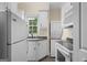 Efficient laundry space featuring a stackable washer/dryer, granite counters and bright white cabinets at 2058 Sewanee Ct, Villa Rica, GA 30180