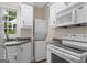 Functional laundry area with white cabinets, granite countertops, and modern appliances at 2058 Sewanee Ct, Villa Rica, GA 30180
