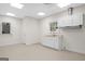 Bright laundry room with white cabinetry, sink, window, and neutral walls at 2058 Sewanee Ct, Villa Rica, GA 30180