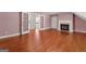 An elegant living room with hardwood floors, a fireplace, and french doors to a staircase at 2058 Sewanee Ct, Villa Rica, GA 30180