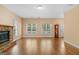 Bright living room featuring a stone fireplace and hardwood floors, with windows overlooking the yard at 2058 Sewanee Ct, Villa Rica, GA 30180