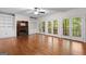 Cozy living room with hardwood floors, fireplace, built-ins, and French doors at 2058 Sewanee Ct, Villa Rica, GA 30180