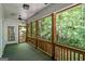 Open screened porch with ceiling fan overlooking a lush, wooded landscape at 2058 Sewanee Ct, Villa Rica, GA 30180