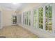 Bright sunroom filled with natural light through large windows, tile floors and ceiling fan at 2058 Sewanee Ct, Villa Rica, GA 30180