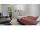 This bedroom has a simple desk, a bed with soft blanket, wall art and a big window for optimal sunlight at 11255 Wittenridge Dr, Alpharetta, GA 30022