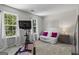 Bright bedroom with lots of sunlight has carpet, white walls, bike trainer, love seat and stylish furnishings at 11255 Wittenridge Dr, Alpharetta, GA 30022