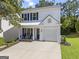Charming two-story home with a well-manicured lawn and a spacious driveway on a sunny day at 11255 Wittenridge Dr, Alpharetta, GA 30022
