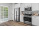 Well-equipped kitchen with stainless steel fridge, oven, and sliding glass door at 11255 Wittenridge Dr, Alpharetta, GA 30022